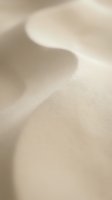 Soft beige fabric with gentle folds and natural texture, creating abstract waves of light and shadow. Suitable for backgrounds, wellness, and design projects.