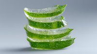 Fresh aloe vera plant slices stacked showing transparent gel and green skin with water drops on gray background, natural organic skincare ingredient.