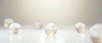Elegant transparent glass spheres with golden accents scattered on reflective white surface creating minimalist luxury composition for premium design projects.