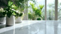 Elegant marble countertop with potted green plants in bright interior space, creating fresh atmosphere for modern home or office design.
