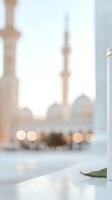 Soft focus view of mosque minarets with bokeh lights creating dreamy atmosphere. White marble architecture and gentle evening glow reflect spiritual tranquility.