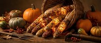 Autumn harvest display with colorful corn ears spilling from wicker basket surrounded by pumpkins and gourds on rustic wooden surface for seasonal decoration.