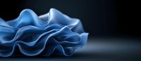 Elegant blue fabric waves creating smooth flowing curves and folds against dark background, showcasing luxurious textile movement and graceful design elements.