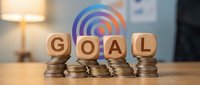 Wooden blocks spelling GOAL on stacks of coins with colorful target symbol, representing financial planning and achievement strategies for success.