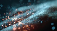 Macro abstract background with glowing orange and blue bokeh lights on textured dark surface, creating atmospheric depth for creative design projects.