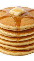 Stack of golden pancakes with melting butter on top and maple syrup dripping down the sides, isolated on white background for breakfast and brunch design use.