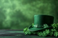 Green leprechaun hat with shamrock decoration on wooden surface against blurred forest background, perfect for St. Patrick's Day celebrations.