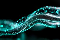 Glowing turquoise particles form elegant flowing waves against dark background, creating dynamic motion effect with bokeh and light trails for technology designs.