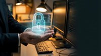 Cybersecurity expert holding glowing padlock hologram over keyboard, representing digital protection, data security, and encryption technology in modern workspace.
