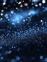 Magical blue glowing particles and bokeh lights scattered on dark background create dreamy atmosphere for festive designs and holiday projects.