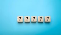 Five wooden blocks with question marks arranged in row on bright blue background for business problem solving and decision making concepts.