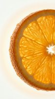 Fresh orange slice cross-section with vibrant yellow flesh and textured peel against neutral background, suitable for food, beverage, health, and wellness design projects.