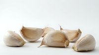 Isolated garlic cloves on white background, ready for culinary, food packaging, recipe, cooking website, restaurant menu, and nutritional content design use.