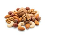 Mixed nuts collection with almonds walnuts cashews hazelnuts on white background isolated for healthy snacking cooking baking nutritious food design.