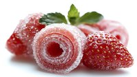 Fresh strawberries with sugar-coated fruit roll candy on white background. Sweet treats and berries for dessert recipes and healthy snacking concepts.