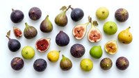 Fresh figs collection with whole and sliced fruits showing red flesh interior, isolated on white background for culinary and healthy eating designs.