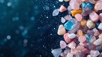 Colorful healing crystals and mineral stones on dark blue background with bokeh effect and copy space, spiritual wellness concept for meditation practice.
