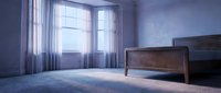 Spacious bedroom with wooden bed frame, sheer curtains filtering natural light through large windows, soft blue-toned walls, and plush carpet flooring. Suitable for interior design, real estate, and home decor projects.