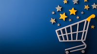 Shopping cart with golden and silver glittering stars floating above on deep blue background, symbolizing luxury retail and premium shopping experience.