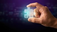 Hand holding glowing puzzle piece against dark background, symbolizing solutions, problem-solving, and business strategy for corporate concepts.