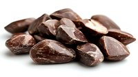 Pile of polished brown gemstones with natural marbled patterns and glossy surface finish isolated on white background for jewelry design projects.