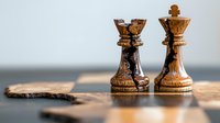 Wooden chess pieces king and queen standing together on chessboard with soft focus background, representing strategy, leadership and partnership.