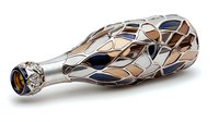 Decorative glass bottle with metallic silver overlay featuring geometric mosaic pattern in brown and blue tones on white background, isolated on white surface.