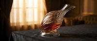Elegant crystal decanter filled with amber whiskey or cognac on dark surface with warm golden lighting creating luxurious atmosphere for premium spirits enjoyment.