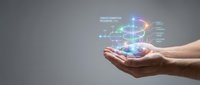 Hands holding holographic digital transformation concept with glowing network connections and data visualization elements on gray background.