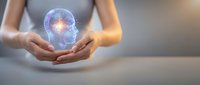 Hands holding glowing brain hologram with neural connections, representing artificial intelligence, innovation, and digital technology concepts for business and science applications.