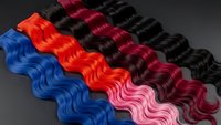 Colorful hair extensions in vibrant blue, red, pink and black shades with wavy texture for beauty salon styling and fashion transformation projects.