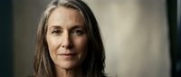 Mature woman with long gray hair and fair complexion, displaying a calm, confident expression. Suitable for healthcare, wellness, aging gracefully, professional portraits, and lifestyle editorial use.