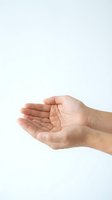 Open cupped hands gesture on white background showing palm and fingers in receiving position for charity, giving, support concepts.