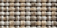 Woven natural linen fabric texture in beige and gray tones showing detailed basket weave pattern. Seamless textile background.