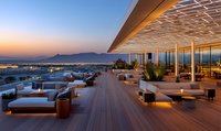 Luxurious rooftop terrace with loungers and dining areas at sunset, featuring wooden deck, modern furniture, ambient lighting and panoramic mountain views.