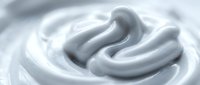 Smooth white cream swirl with flowing texture for cosmetic skincare beauty product packaging design and marketing materials.