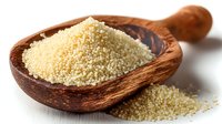 Raw couscous grains in wooden scoop on white background, traditional North African ingredient for Mediterranean cuisine.