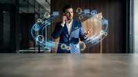 Young male professional in blue business suit interacting with glowing digital network interface, representing global connectivity, data management, and modern technology solutions for corporate environments.