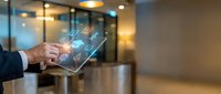 Businessman holding transparent tablet with glowing digital shopping icons and e-commerce symbols in modern office environment for retail and online business concepts.