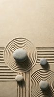 Zen garden with raked sand patterns and smooth stones creating peaceful meditation space for mindfulness and relaxation practices.