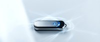 Modern black USB flash drive with blue LED indicator on white surface for data storage and file transfer technology concepts.