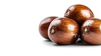 Fresh raw chestnuts with glossy brown shells isolated on white background, macro view showing natural texture and details for seasonal cooking.