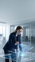 Professional businesswoman using futuristic holographic interface technology in modern office environment for digital innovation and data analysis.