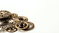 Vintage brass clockwork gears and mechanical parts arranged on white background for steampunk design projects and industrial crafts.