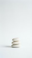Minimalist zen stone stack on clean white background for meditation wellness spa and mindfulness concepts.