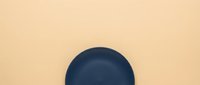 Dark blue sphere on neutral beige background, isolated and ready for design use in web graphics, presentations, and digital projects.
