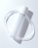 Minimalist white cosmetic bottle with dynamic swirling water splash effect on light background, creating elegant motion and transparency for skincare packaging design.