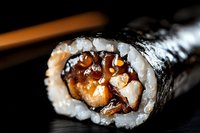 Fresh sushi roll with grilled eel and rice wrapped in nori seaweed on dark background for Japanese cuisine menu and restaurant advertising.