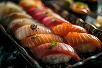 Assorted fresh nigiri sushi with salmon, tuna, and white fish topped with caviar and herbs arranged in elegant platter for gourmet dining experience.