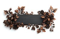 Black wooden board with copper metallic floral arrangement featuring pinecones and autumn leaves, isolated on white background for design projects and seasonal decor.